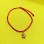Red Braided Cotton Swirly Bracelet with an Gold Color Starfish Pendant